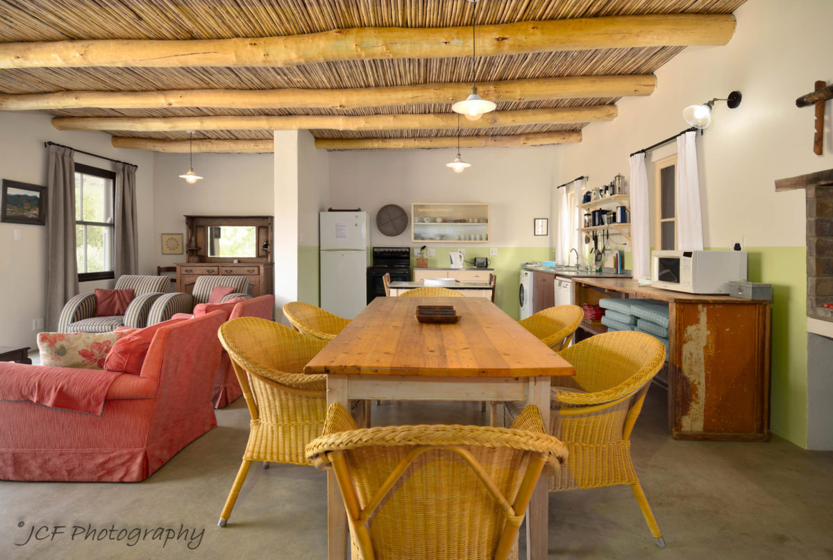 open-plan kitchen, dining area and braai at bokwagtershuis matjiesvlei cottages accommodation