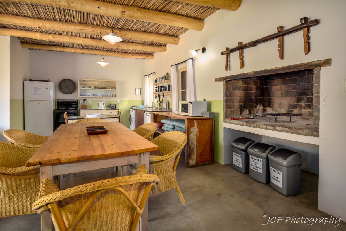 open-plan kitchen, dining area and braai at bokwagtershuis matjiesvlei cottages accommodation